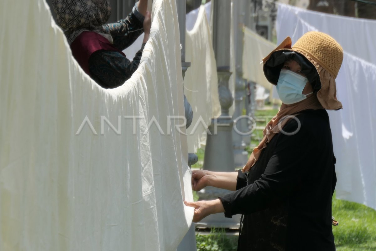 Mencuci kain kafan dengan air zamzam